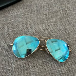 Blue Raybans with gold rims